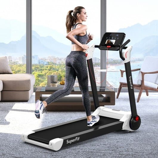 Folding home office treadmill in a clean remote work setup with standing desk and modern workspace organization.