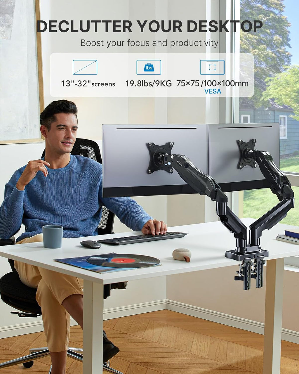 Person sitting at a desk with 2-display monitors stand for remote work setup.